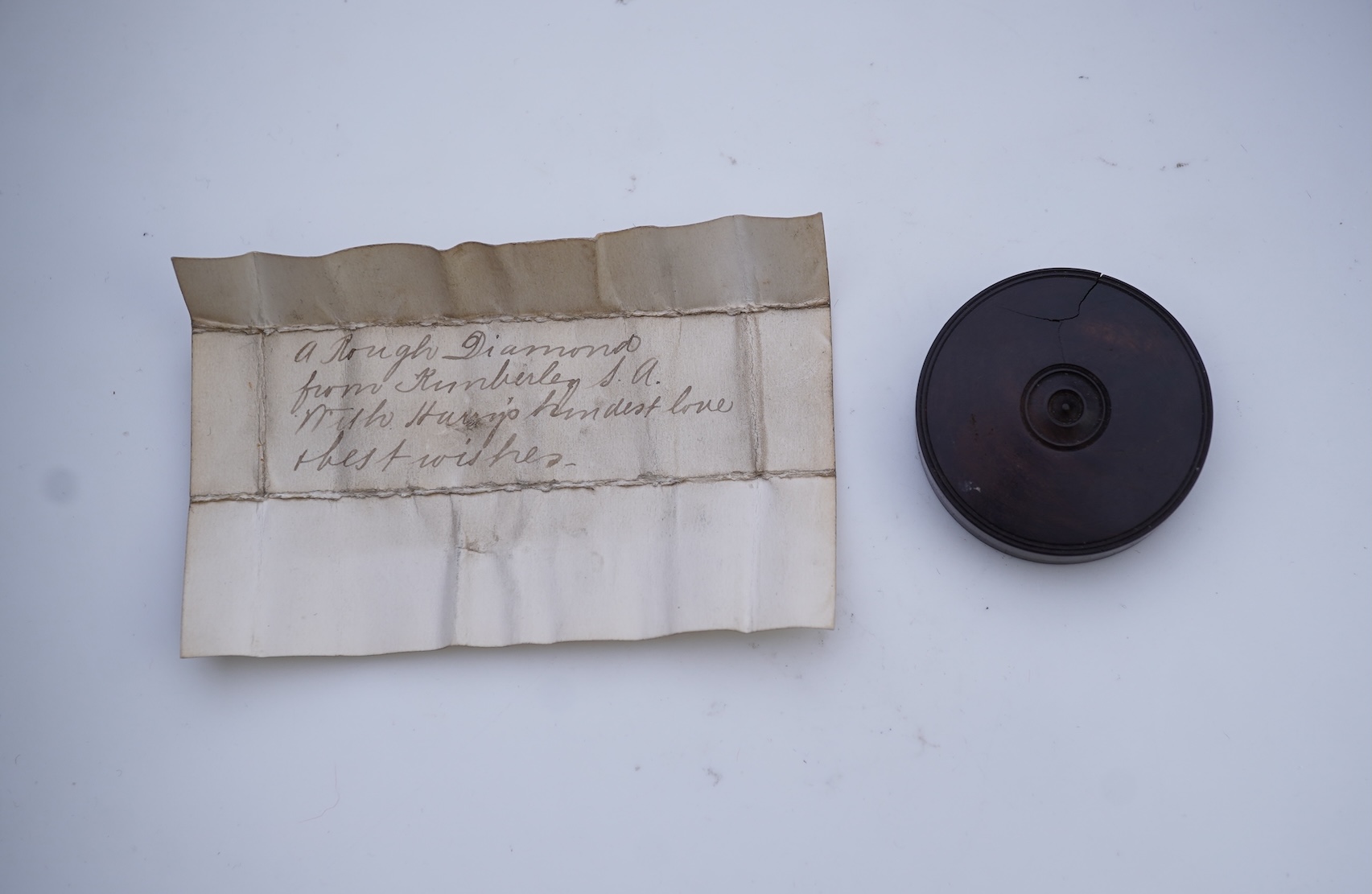 A rough diamond, with accompanying box and note, late 19th century